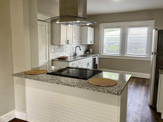 3227 Guilford Ave, Indianapolis, IN 46205 - kitchen with island range hood, appliances with stainless steel finishes, light stone counters, and white cabinetry