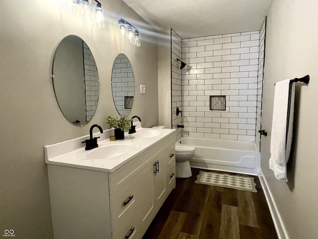 3227 Guilford Ave, Indianapolis, IN 46205 - full bathroom featuring double vanity, wood finished floors, and shower / tub combination