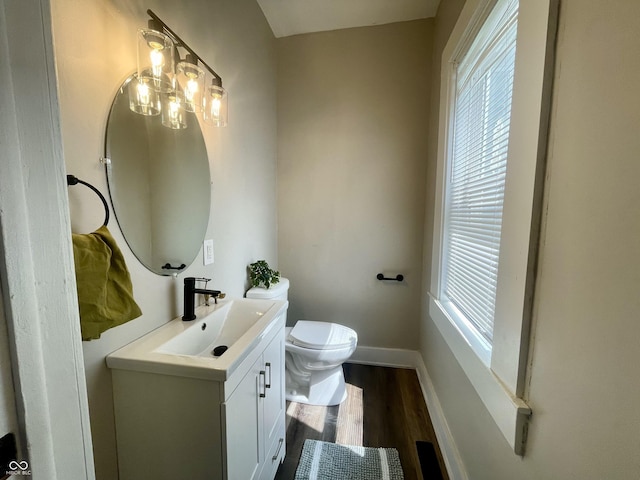 3227 Guilford Ave, Indianapolis, IN 46205 - half bath with vanity, plenty of natural light, and wood finished floors
