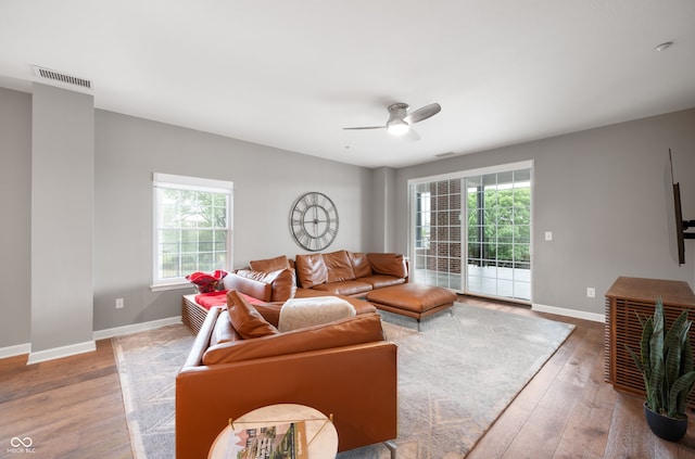 435 Virginia Ave Unit 101, Indianapolis, IN 46203 - living room featuring healthy amount of natural light, hardwood / wood-style flooring, a ceiling fan, and baseboards