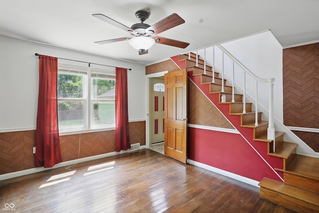 2905 N Warman Ave, Indianapolis, IN 46222 - stairs featuring wainscoting, hardwood / wood-style flooring, ceiling fan, and wooden walls