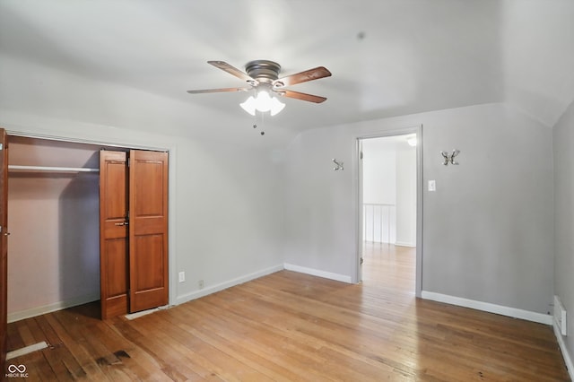2905 N Warman Ave, Indianapolis, IN 46222 - unfurnished bedroom featuring wood-type flooring, lofted ceiling, baseboards, a closet, and ceiling fan