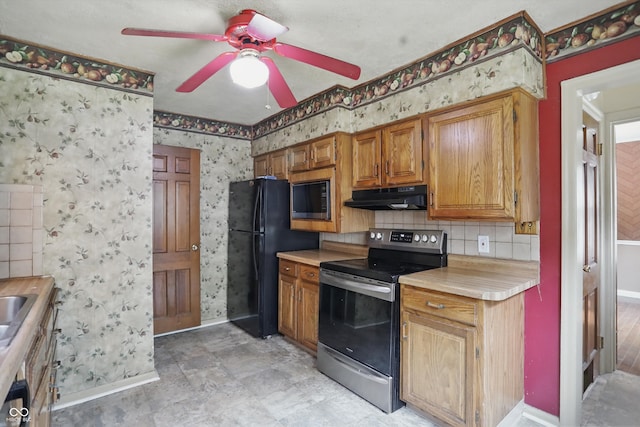 2905 N Warman Ave, Indianapolis, IN 46222 - kitchen with black appliances, baseboards, under cabinet range hood, light countertops, and a ceiling fan