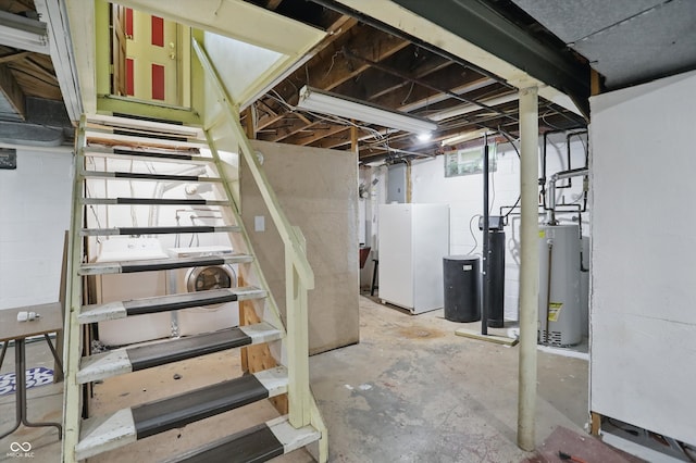 2905 N Warman Ave, Indianapolis, IN 46222 - unfinished below grade area with water heater, stairs, and freestanding refrigerator