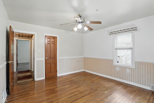 2905 N Warman Ave, Indianapolis, IN 46222 - spare room with hardwood / wood-style floors, ceiling fan, and a wainscoted wall