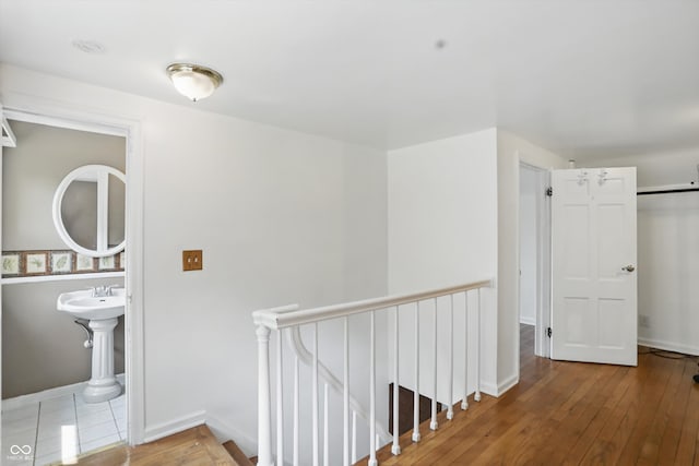 2905 N Warman Ave, Indianapolis, IN 46222 - hall with an upstairs landing, wood-type flooring, and baseboards