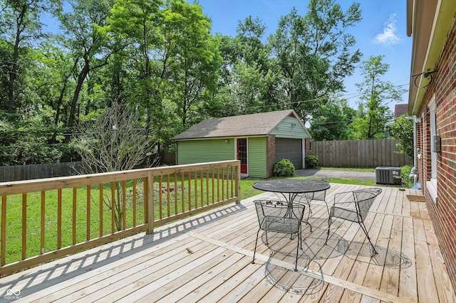 2905 N Warman Ave, Indianapolis, IN 46222 - wooden deck with a garage, an outbuilding, central air condition unit, outdoor dining space, and driveway