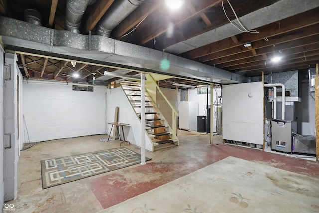 2905 N Warman Ave, Indianapolis, IN 46222 - unfinished basement with freestanding refrigerator, stairs, and heating unit