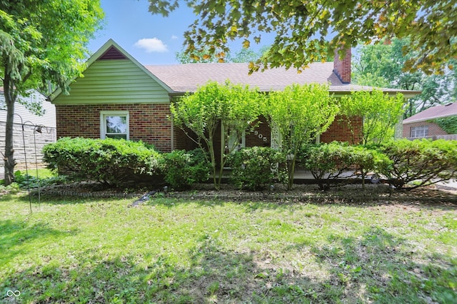 2905 N Warman Ave, Indianapolis, IN 46222 - view of front of property with a chimney, brick siding, and a front yard