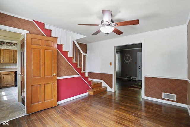2905 N Warman Ave, Indianapolis, IN 46222 - unfurnished room featuring stairway, a wainscoted wall, ceiling fan, wood-type flooring, and ornamental molding