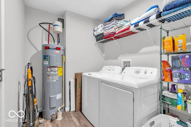 123 Campus Ln, Greenwood, IN 46143 - laundry room with water heater, independent washer and dryer, and light wood-style flooring