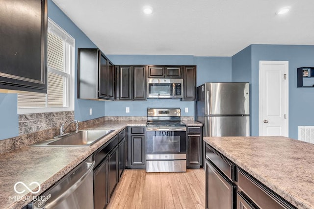 123 Campus Ln, Greenwood, IN 46143 - kitchen with stainless steel appliances, a sink, light wood finished floors, recessed lighting, and dark brown cabinetry