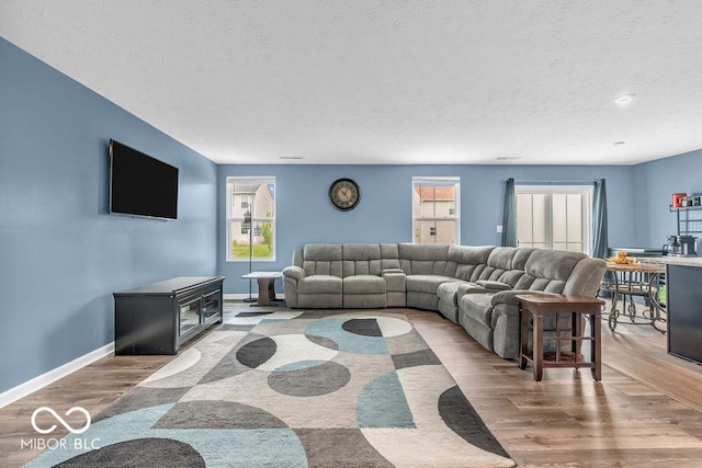 123 Campus Ln, Greenwood, IN 46143 - living room with a textured ceiling, wood finished floors, and baseboards