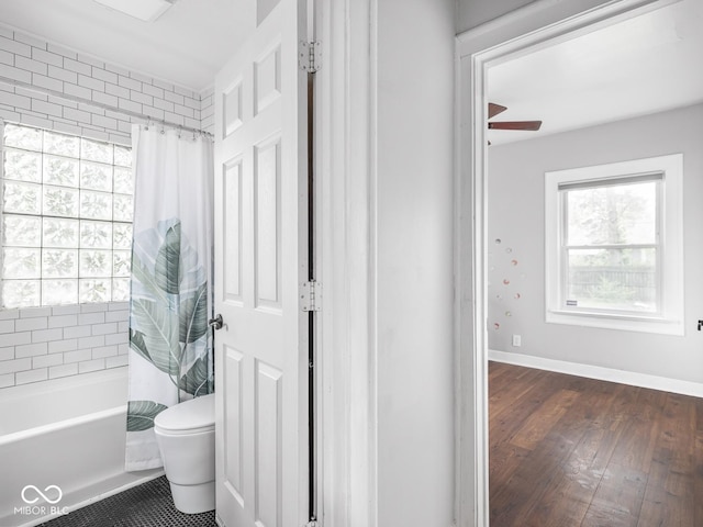1617 E 52nd St, Indianapolis, IN 46205 - full bath featuring toilet, shower / tub combo, wood finished floors, baseboards, and ceiling fan