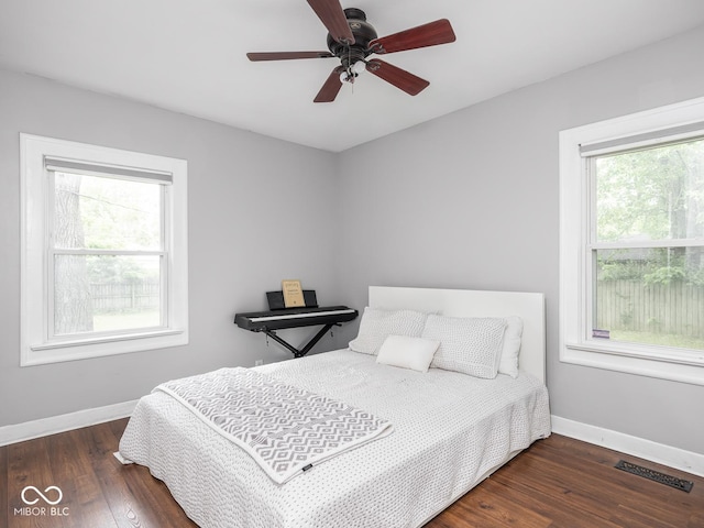 1617 E 52nd St, Indianapolis, IN 46205 - bedroom featuring multiple windows, baseboards, and wood finished floors