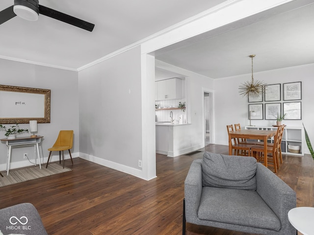 1617 E 52nd St, Indianapolis, IN 46205 - living area with ornamental molding, baseboards, wood finished floors, a ceiling fan, and a chandelier