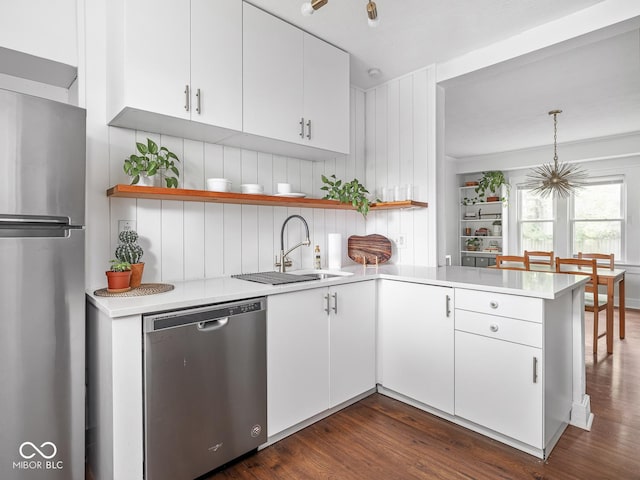 1617 E 52nd St, Indianapolis, IN 46205 - kitchen featuring appliances with stainless steel finishes, a sink, open shelves, a peninsula, and light countertops