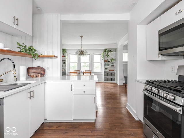 1617 E 52nd St, Indianapolis, IN 46205 - kitchen with stainless steel appliances, a sink, light countertops, dark wood-style floors, and open shelves