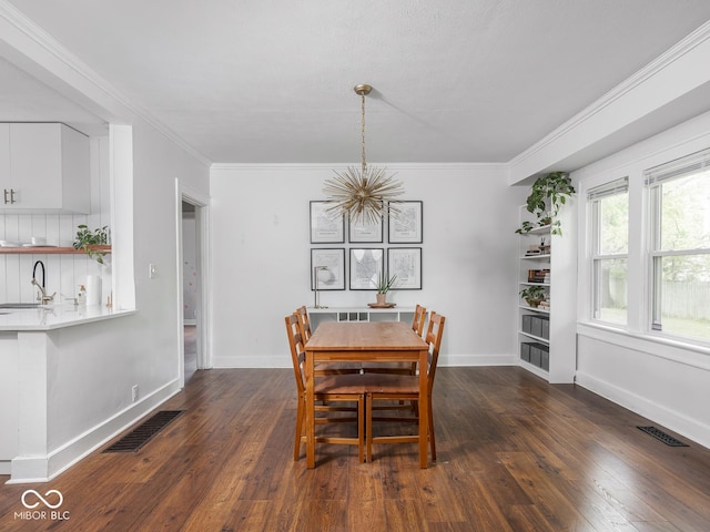 1617 E 52nd St, Indianapolis, IN 46205 - dining area featuring a chandelier, dark wood-style flooring, baseboards, and ornamental molding