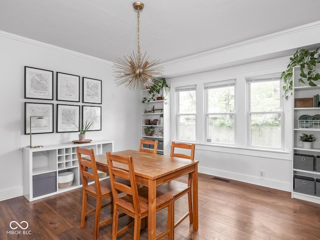 1617 E 52nd St, Indianapolis, IN 46205 - dining area featuring a chandelier, crown molding, wood finished floors, and baseboards