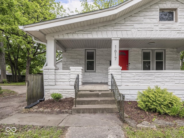 1617 E 52nd St, Indianapolis, IN 46205 - view of front facade featuring a porch and stone siding