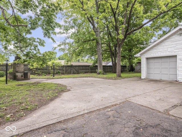 1617 E 52nd St, Indianapolis, IN 46205 - view of yard featuring concrete driveway and a garage