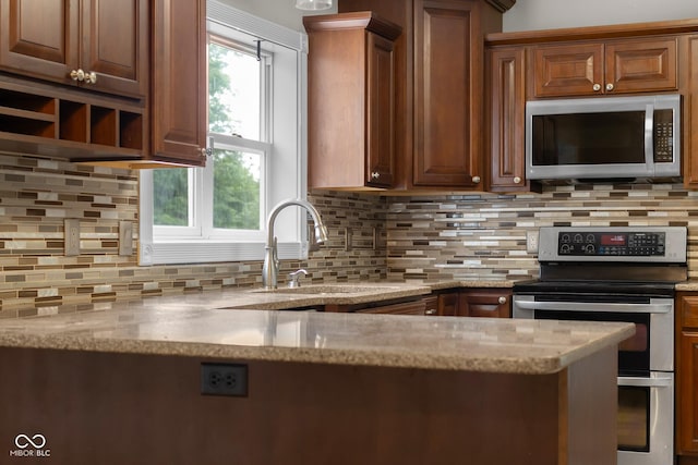 12383 S 25 W, Columbus, IN 47201 - kitchen featuring appliances with stainless steel finishes, a sink, backsplash, and light stone countertops