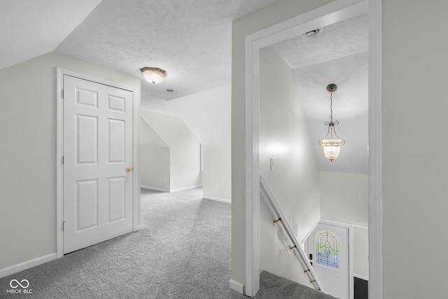 12383 S 25 W, Columbus, IN 47201 - corridor featuring an upstairs landing, vaulted ceiling, carpet floors, baseboards, and a textured ceiling