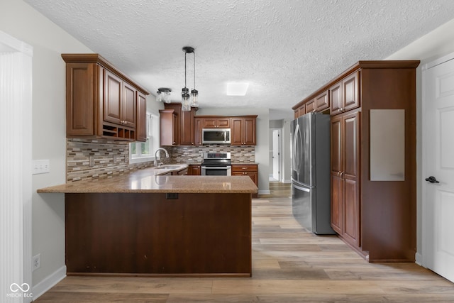 12383 S 25 W, Columbus, IN 47201 - kitchen with stainless steel appliances, a peninsula, decorative backsplash, light wood finished floors, and light stone countertops