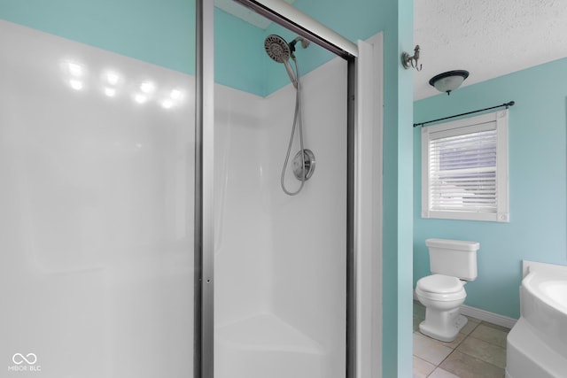 12383 S 25 W, Columbus, IN 47201 - bathroom with a stall shower, tile patterned floors, toilet, baseboards, and a textured ceiling