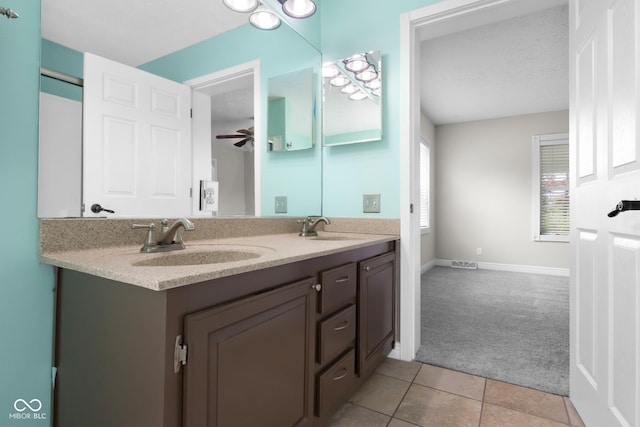 12383 S 25 W, Columbus, IN 47201 - bathroom with double vanity, tile patterned floors, baseboards, and a ceiling fan
