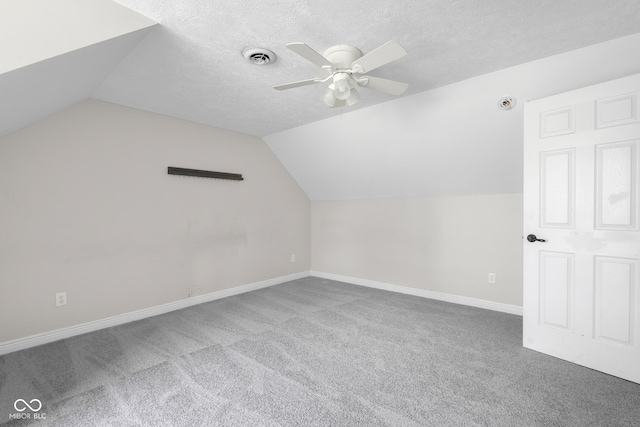 12383 S 25 W, Columbus, IN 47201 - additional living space featuring vaulted ceiling, carpet floors, ceiling fan, baseboards, and a textured ceiling