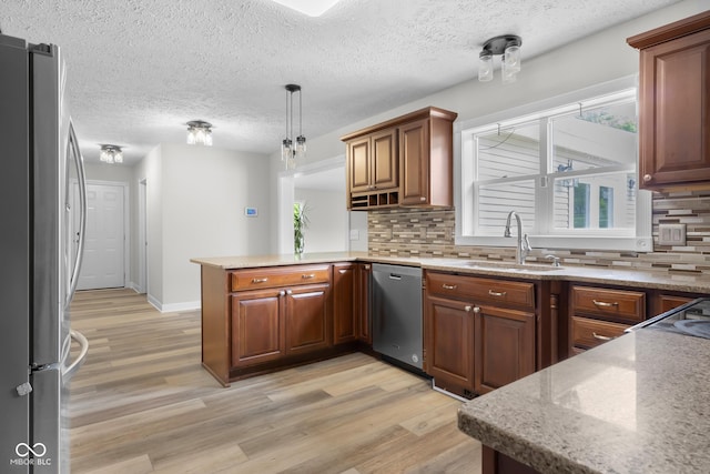 12383 S 25 W, Columbus, IN 47201 - kitchen featuring appliances with stainless steel finishes, a sink, a peninsula, light wood-style flooring, and decorative backsplash