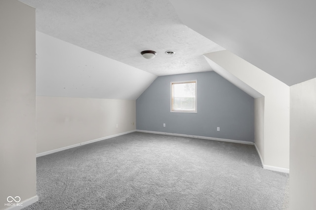 12383 S 25 W, Columbus, IN 47201 - bonus room with carpet, lofted ceiling, baseboards, and a textured ceiling