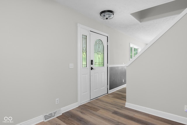 12383 S 25 W, Columbus, IN 47201 - foyer entrance featuring baseboards, dark wood-style flooring, and a textured ceiling
