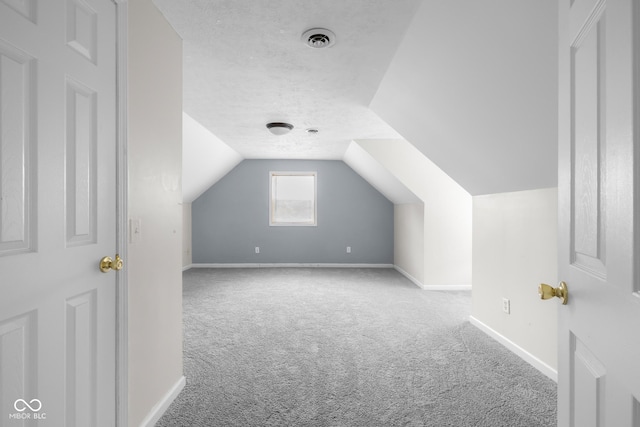 12383 S 25 W, Columbus, IN 47201 - bonus room with carpet flooring, a textured ceiling, baseboards, and lofted ceiling