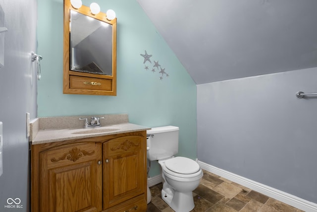 12383 S 25 W, Columbus, IN 47201 - bathroom with toilet, baseboards, vaulted ceiling, vanity, and stone finish floors