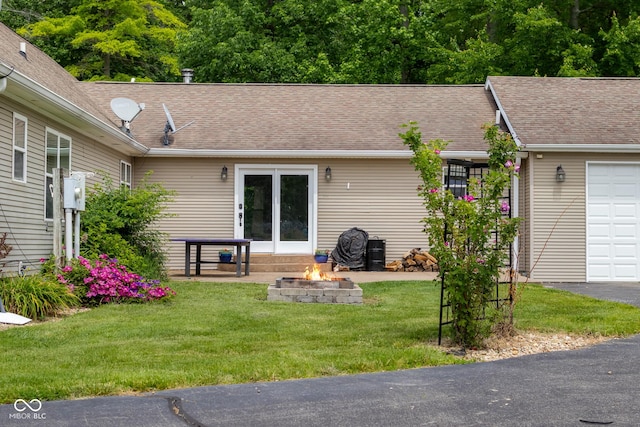 12383 S 25 W, Columbus, IN 47201 - exterior space featuring an outdoor fire pit, a lawn, and a shingled roof