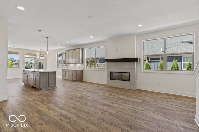 14878 E Keenan Cir Lot 37, Westfield, IN 46074 - kitchen with wood finished floors, recessed lighting, baseboards, a kitchen island with sink, and light countertops