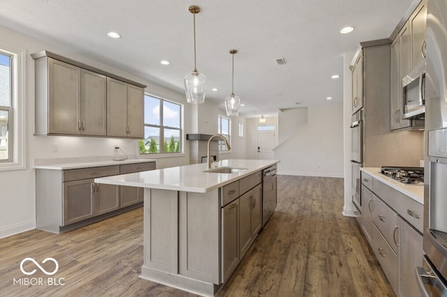 14878 E Keenan Cir Lot 37, Westfield, IN 46074 - kitchen with a sink, light countertops, dark wood-style floors, a kitchen island with sink, and appliances with stainless steel finishes