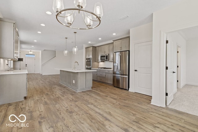 14878 E Keenan Cir Lot 37, Westfield, IN 46074 - kitchen with appliances with stainless steel finishes, a chandelier, light wood-style flooring, recessed lighting, and gray cabinetry