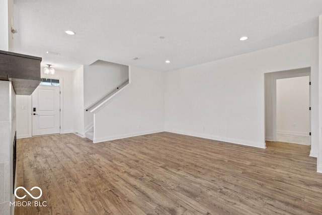 14878 E Keenan Cir Lot 37, Westfield, IN 46074 - unfurnished living room with wood finished floors, stairs, baseboards, and recessed lighting