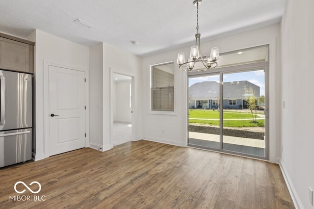 14878 E Keenan Cir Lot 37, Westfield, IN 46074 - unfurnished dining area with a chandelier, wood finished floors, and baseboards