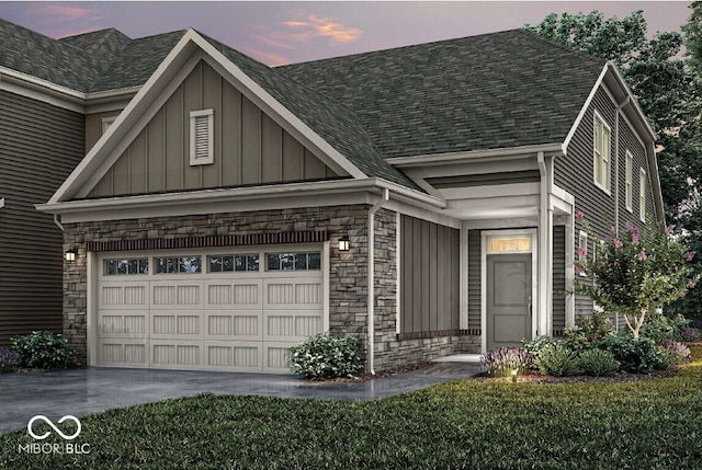 14878 E Keenan Cir Lot 37, Westfield, IN 46074 - view of front of home featuring board and batten siding, an attached garage, driveway, stone siding, and roof with shingles