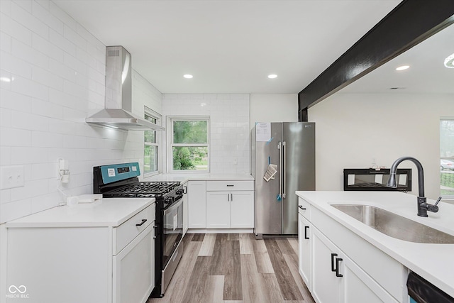 233 N Devon Ave, Indianapolis, IN 46219 - kitchen featuring high end fridge, gas range oven, wall chimney exhaust hood, a sink, and tasteful backsplash