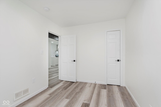 233 N Devon Ave, Indianapolis, IN 46219 - unfurnished bedroom featuring light wood-style flooring and baseboards