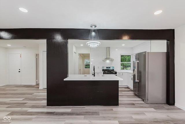 233 N Devon Ave, Indianapolis, IN 46219 - kitchen featuring stainless steel appliances, wall chimney exhaust hood, a sink, white cabinets, and light countertops