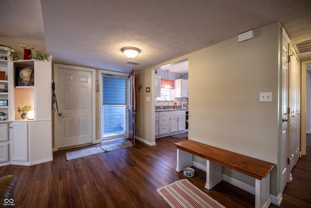 1052 Barley Cir, Carmel, IN 46032 - foyer entrance featuring dark wood-type flooring, baseboards, and a textured ceiling