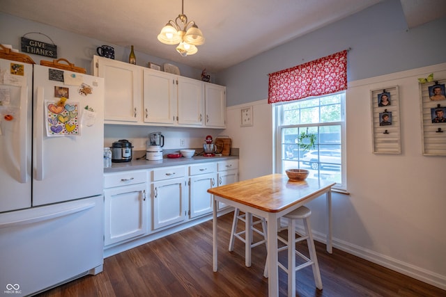 1052 Barley Cir, Carmel, IN 46032 - kitchen with freestanding refrigerator, a chandelier, white cabinetry, dark wood-type flooring, and light countertops