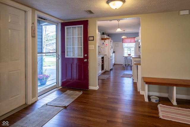 1052 Barley Cir, Carmel, IN 46032 - foyer entrance featuring dark wood-type flooring, a textured ceiling, and baseboards